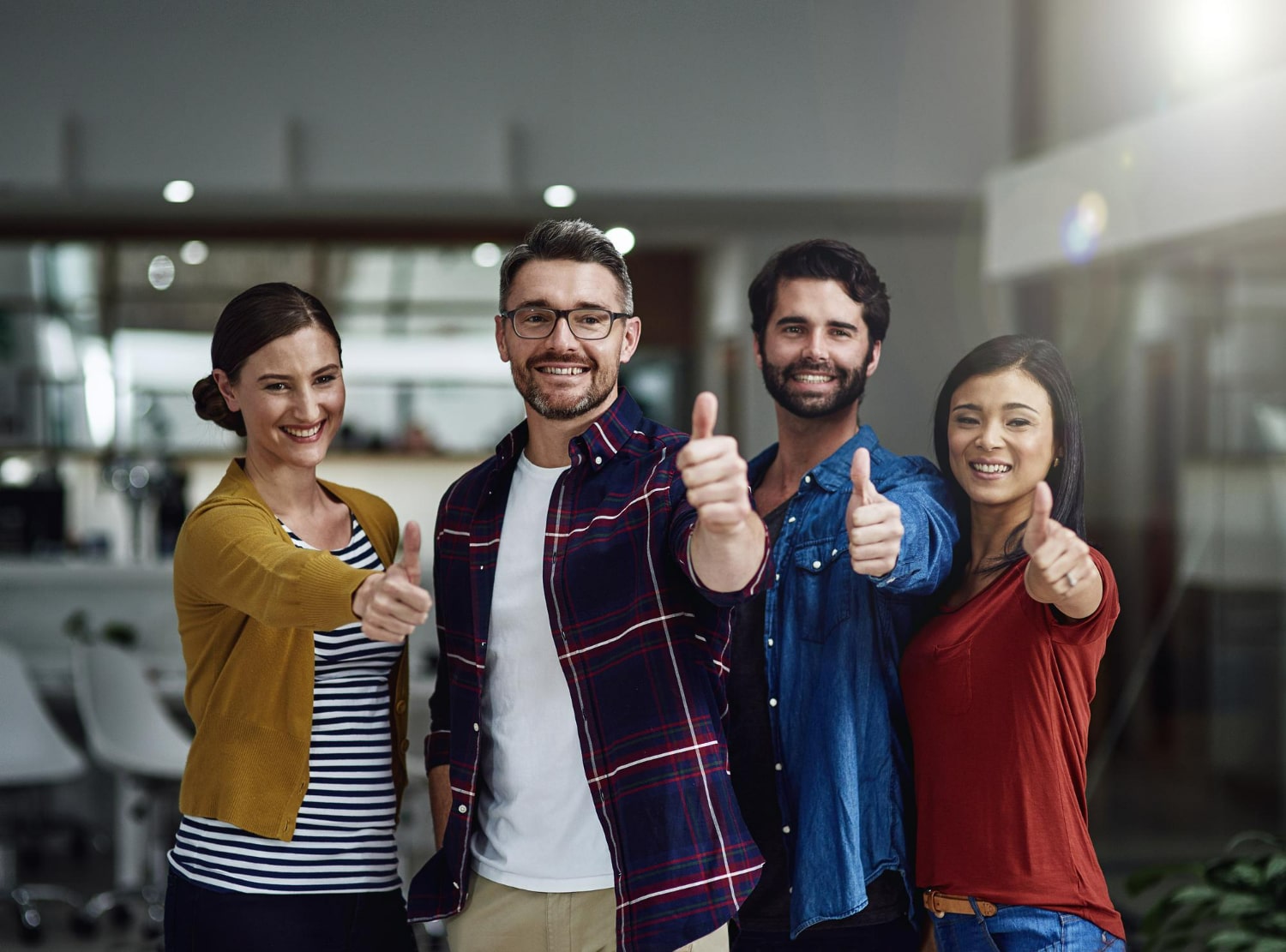 success-is-our-middle-name-portrait-group-businesspeople-showing-thumbs-up-min